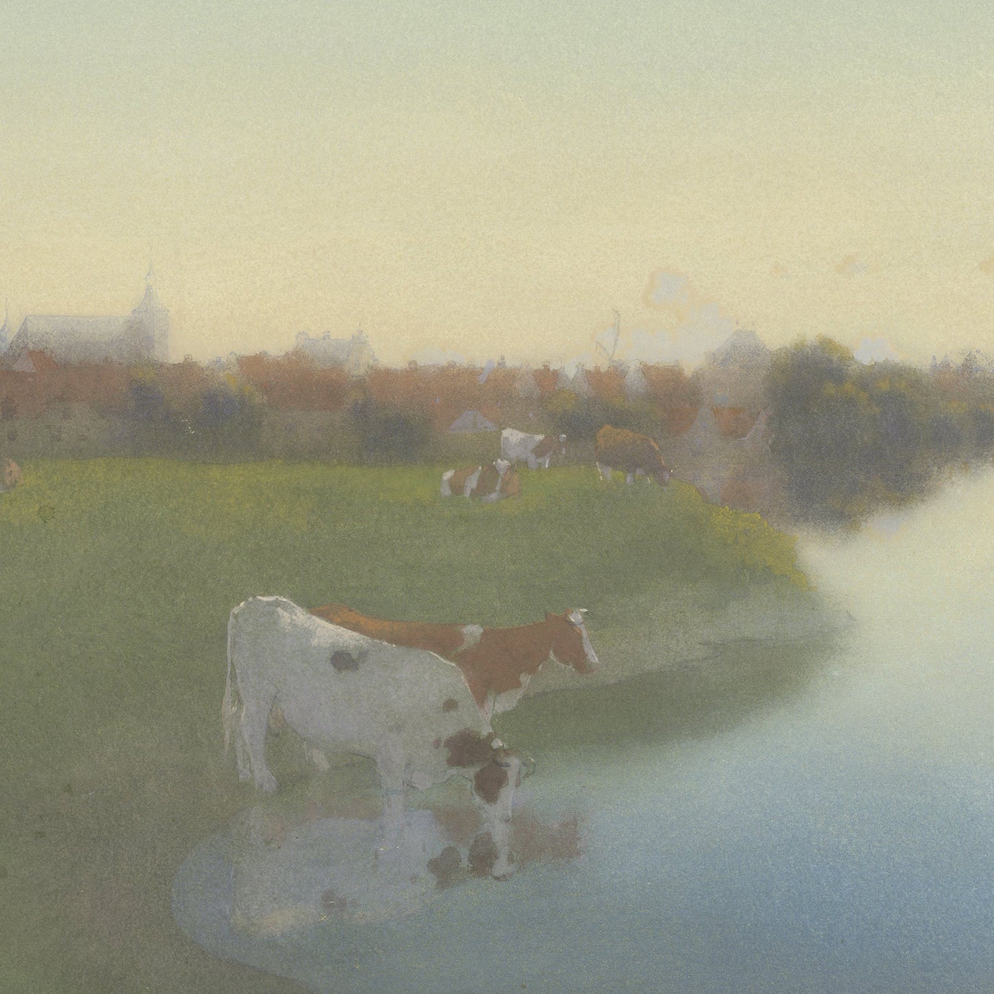 A serene pastoral scene featuring cows grazing near a calm riverbank. The landscape is veiled in soft, misty light, with a village visible in the distance under a pale, warm sky. The water reflects the subdued colors of the peaceful surroundings, characteristic of Jan Voerman's Dutch countryside art titled "Bank Of The River Ijssel Near Hattem.