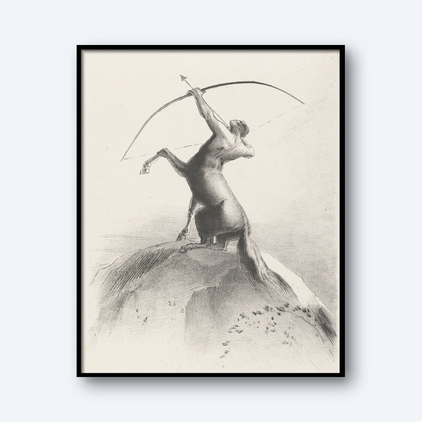 The framed monochromatic drawing, "Centaur Aiming at the Clouds by Odilon Redon," portrays a centaur – a creature with the upper body of a human and the lower body of a horse – standing on its hind legs atop a hill. The centaur is holding a bow and arrow, aiming towards the sky, embodying the essence of astrology wall art and zodiac symbolism.