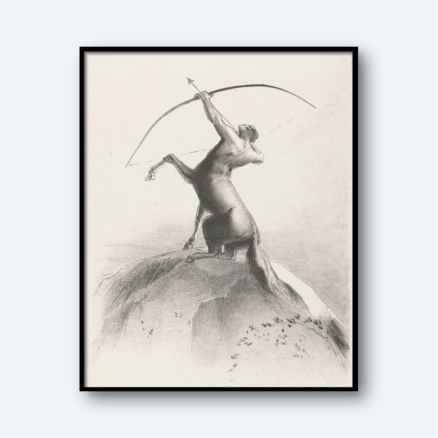 The framed monochromatic drawing, "Centaur Aiming at the Clouds by Odilon Redon," portrays a centaur – a creature with the upper body of a human and the lower body of a horse – standing on its hind legs atop a hill. The centaur is holding a bow and arrow, aiming towards the sky, embodying the essence of astrology wall art and zodiac symbolism.