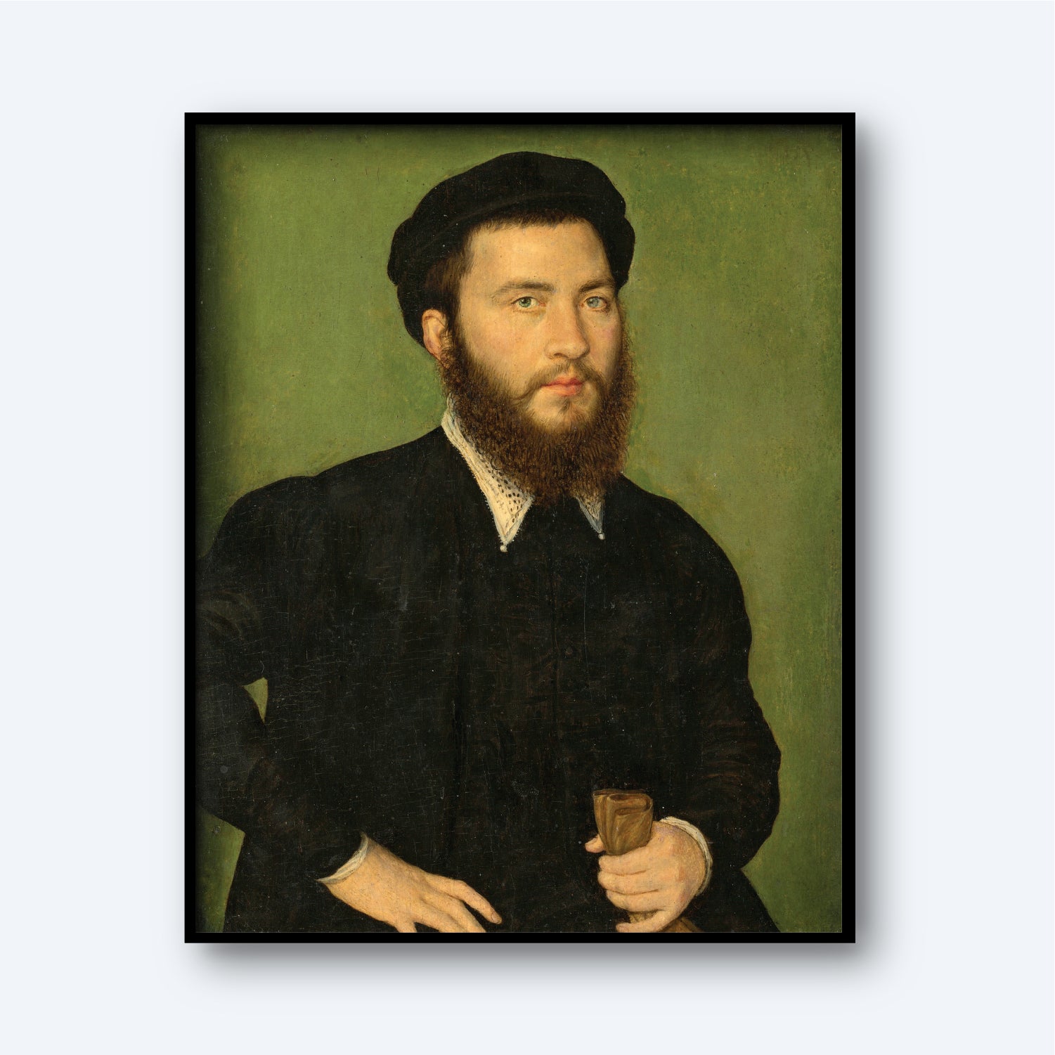 The "Portrait of a Man by Corneille de Lyon" captures the essence of his 16th-century portraiture, depicting a bearded man in a black outfit and cap, holding a small brown object in his left hand. The muted green background and his serious expression emphasize the meticulous detail, all framed in black.