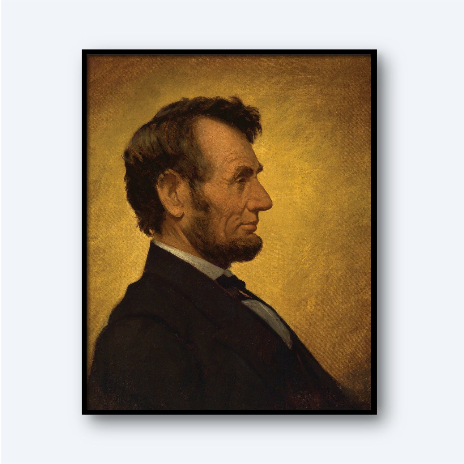 A portrait titled "Abraham Lincoln by William Willard" depicts a man in a black suit with a white shirt and black bow tie. The subject, bearing a striking resemblance to the iconic President Abraham Lincoln, features his distinctive hairstyle and beard. He is shown in profile against a golden-brown background, and the painting is elegantly framed in a black rectangular frame.