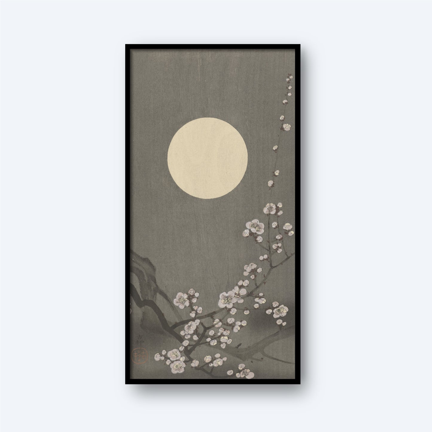 The framed artwork titled "Blooming plum blossom at full moon by Ohara Koson" showcases a large, glowing moon in the background against an olive-gray sky. In the foreground, delicate plum blossom branches with white flowers extend from the lower right, creating a serene and tranquil scene reminiscent of traditional Japanese art by Ohara Koson.