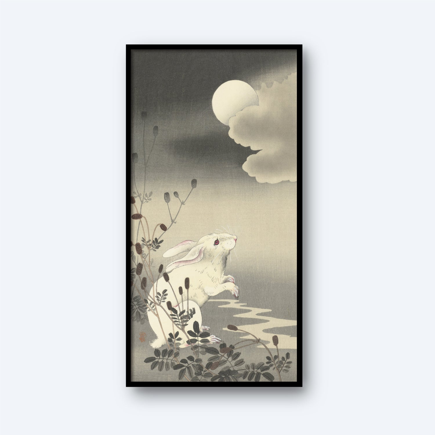 A framed artwork titled "Rabbit at Full Moon by Ohara Koson" portrays a white rabbit standing on its hind legs among plants, gazing up at a cloudy, moonlit sky. The scene, reminiscent of Japanese art by the famous artist Ohara Koson, features stylized botanical elements in the foreground and evokes a calm and serene nocturnal atmosphere.