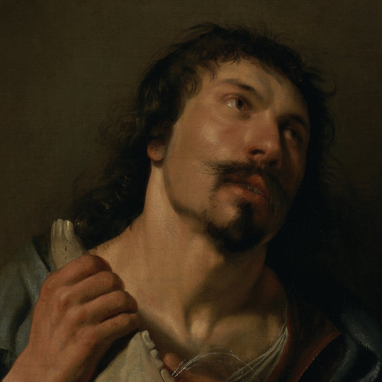 The painting "Samson with the Jawbone" by Salomon de Bray depicts a man with long, dark hair and a mustache gazing upwards with a contemplative expression. He holds a feather close to his chest and wears a dark blue cloak over a white garment. The background is dark and muted, capturing the essence of biblical art.