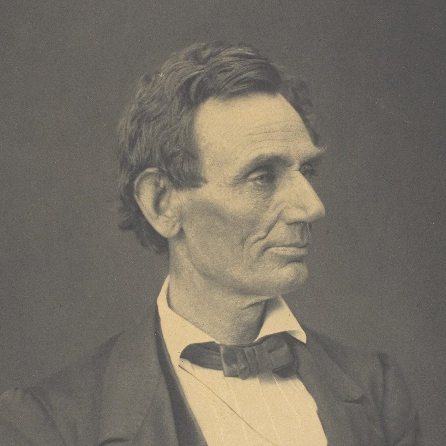 A sepia-toned portrait by Alexander Hesler featuring Abraham Lincoln, showcasing a stern-looking man with deep-set eyes, prominent cheekbones, and wavy hair combed back. He is dressed in a dark jacket, a white shirt with vertical stripes, and a black bow tie. The plain dark background makes this piece perfect as iconic wall art.