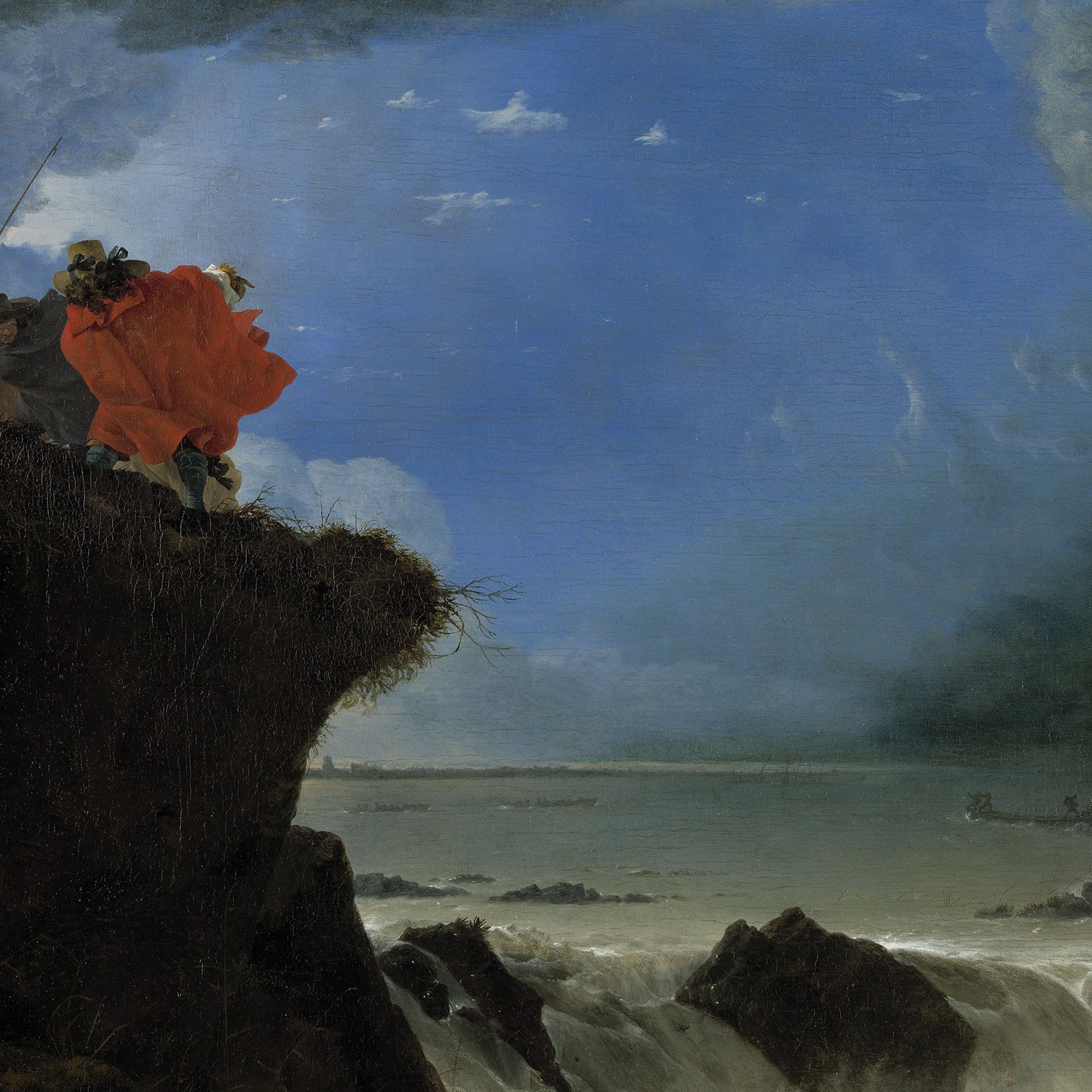 In "The Breach of the Saint Anthony’s Dike near Amsterdam Print," two figures stand at the edge of a cliff overlooking a stormy sea. One figure wears a billowing red cloak, while the other holds a staff. Dark clouds loom above, contrasting with a patch of blue sky and turbulent waves below, invoking Dutch history painting vibes in this dramatic piece of natural disaster art.