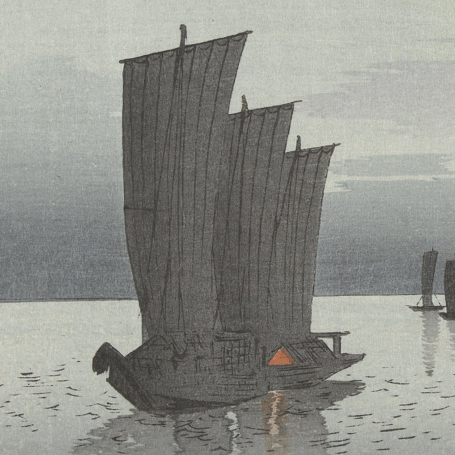 The tranquil image, titled "Ohara Koson – Fishing Boats at Sea," captures a traditional Japanese sailboat gracefully gliding on calm waters at dusk. The boat, evoking the style of Japanese woodblock prints, showcases multiple tall, rectangular sails that appear slightly weathered. Its reflection shimmers on the placid surface of the water beneath a sky that's a gradient of soft hues.