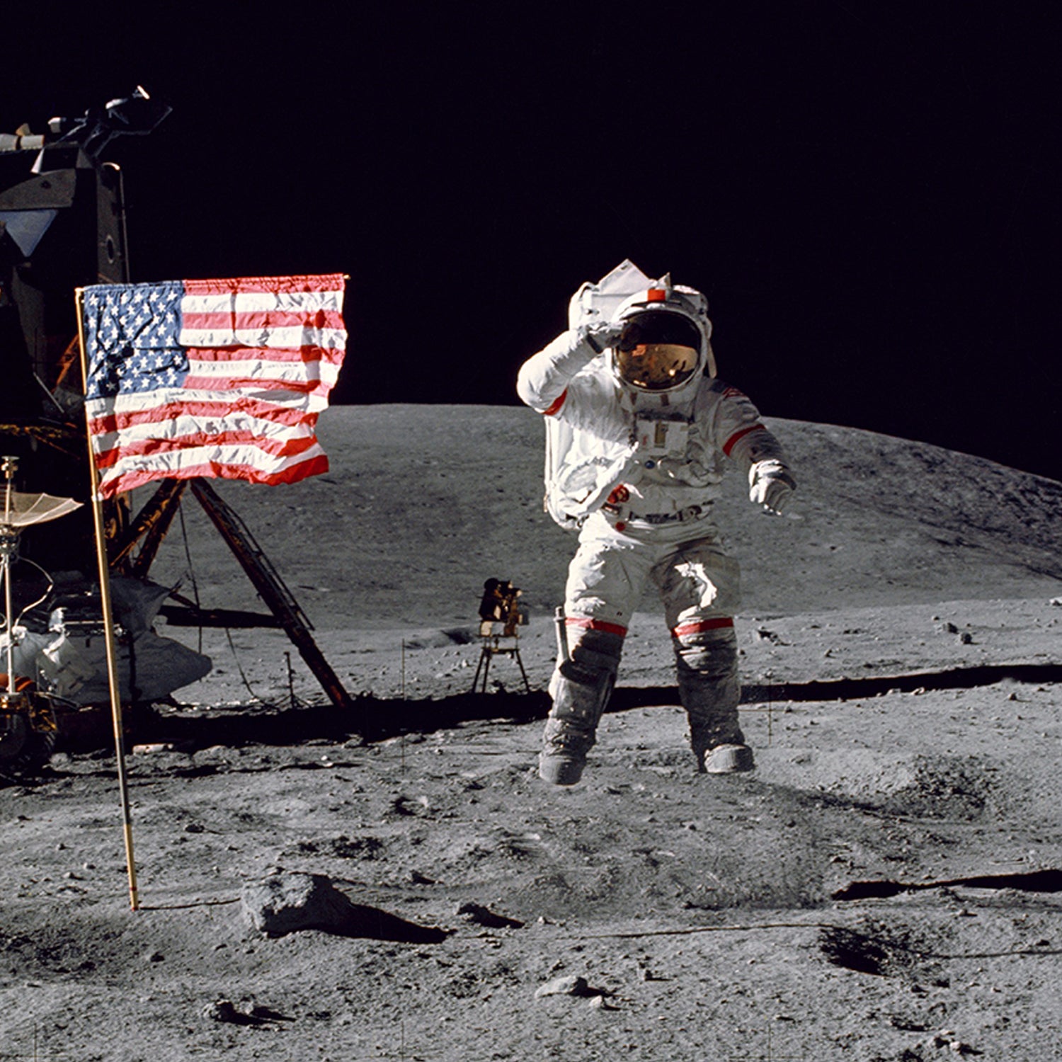 An astronaut in a spacesuit is jumping and saluting on the surface of the moon, as portrayed in NASA's Apollo 1972 - 5th Moon Landing. To the left stands an American flag, with a lunar lander partially visible behind it. The lunar landscape and dark sky create a dramatic backdrop, emphasizing this iconic moment in space exploration history.
