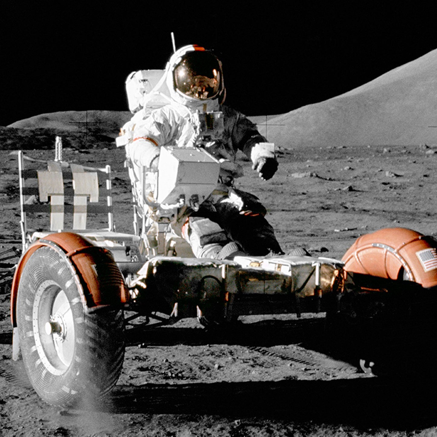 A NASA astronaut, clad in a spacesuit, sits and drives the NASA Apollo 17 Lunar Rover Vehicle on the moon's surface. With dark skies and distant lunar hills in the background, the astronaut's helmet visor reflects the surroundings. The lunar rover's tire tracks are visible on the ground, highlighting space exploration.