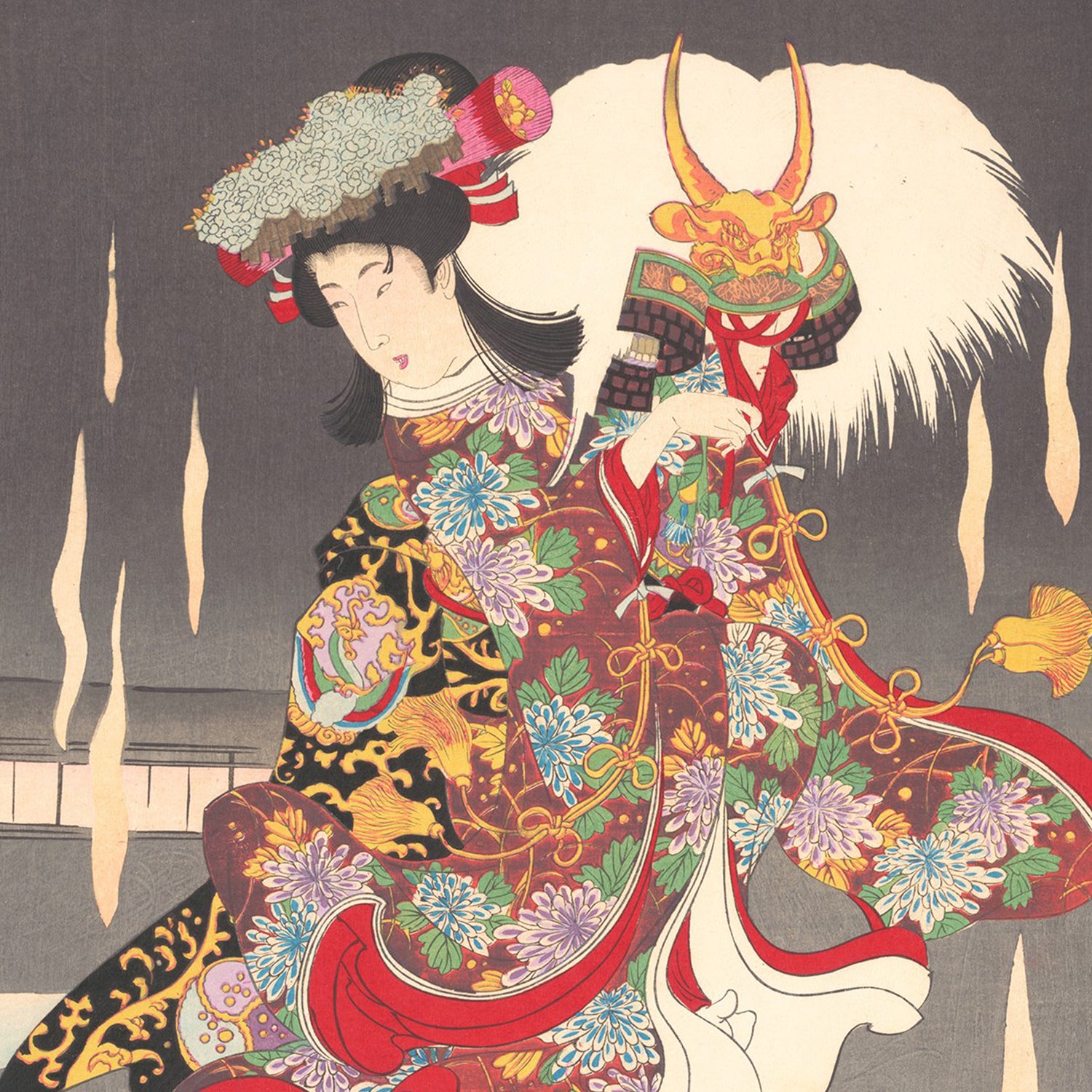 A traditional Japanese artwork, titled "Scene of Foxfire (Kitsunebi) from the Play Honchô nijûshikô" by Toyohara Chikanobu, depicts a woman in an elaborate kimono adorned with floral patterns and a dragon motif. She holds a fierce oni mask, complete with horns and a mane. The background features dark gradient tones accentuated by vertical streaks.