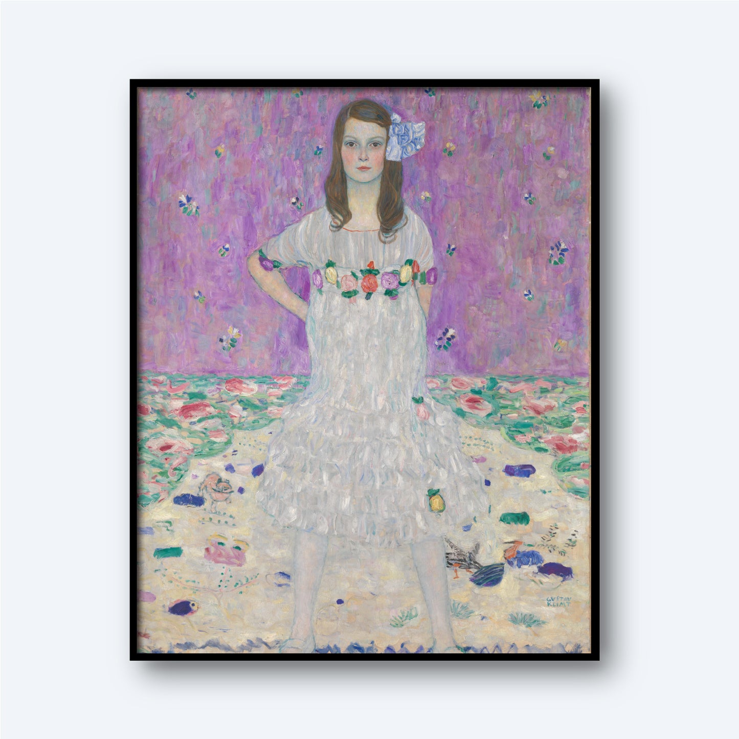 The Mäda Primavesi by Gustav Klimt Print features a young girl standing confidently with her hands on her hips, dressed in a white gown adorned with floral accents and a blue ribbon in her hair. The artwork’s purple backdrop is decorated with floral patterns, and the ground is a blend of pastels and more floral designs, reflecting Gustav Klimt's iconic style that beautifully captures the essence of early 20th-century portraiture.