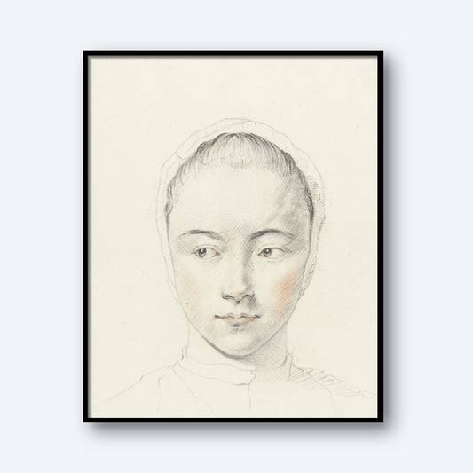 A framed sketch of a young woman with a serene expression. This delicate pencil portrait, titled *Kop van een meisje by Judith M. Testart,* features slight touches of color highlighting her cheeks. She wears a headscarf, and the plain white background makes her the focal point of this exquisite wall art.