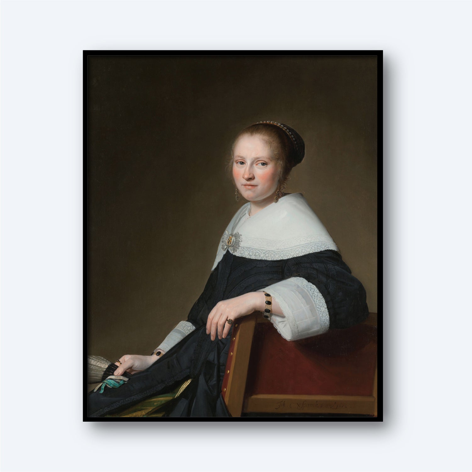 A portrait painting titled "Portrait of Maria van Strijp by Johannes Cornelisz" depicts a woman seated, dressed in a dark gown featuring elaborate white lace cuffs and a large white collar. She gazes toward the viewer, her hair neatly styled and adorned with a decorative headpiece. The dark background enhances the emphasis on the woman, evoking the elegance of the Dutch Golden Age in true Cornelisz fashion.