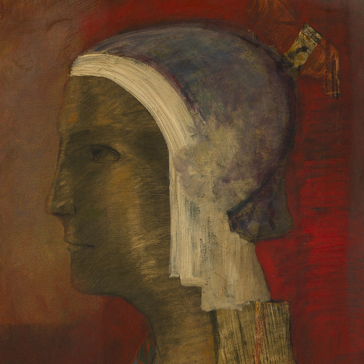 Symbolic Head by Odilon Redon features a painting of a person's profile with a contemplative expression, head turned to the left. The subject is adorned with a head covering in mixed shades of blue, white, and beige, set against a deep red background. Emblematic of Redon's Symbolist movement, the style is abstract with richly textured brushstrokes.