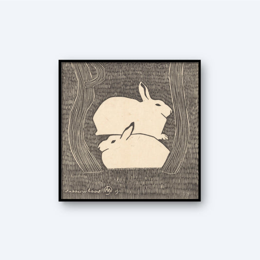 The "Two Snow Hares by Samuel Jessurun de Mesquita Print" showcases a monochromatic artwork where two snow hares are nestled together, surrounded by abstract tree shapes. The image features a textured background and Samuel Jessurun de Mesquita's signature in the lower left corner.