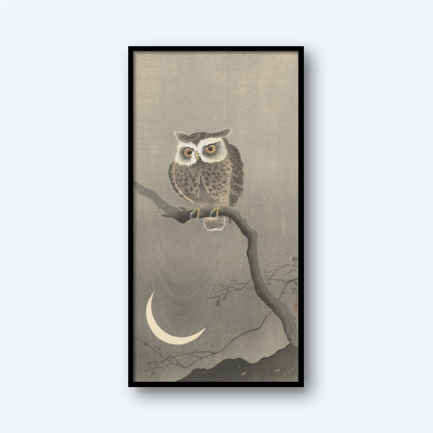 The framed product, titled "Long-eared Owl on Bare Tree Branch by Ohara Koson Vintage Japanese Print," showcases a Long-eared Owl perched on a bare branch against a gray background. Below the owl is a crescent moon, and faint outlines of mountains can be seen at the bottom, evoking the serene nighttime ambiance reminiscent of Ohara Koson's vintage Japanese prints.