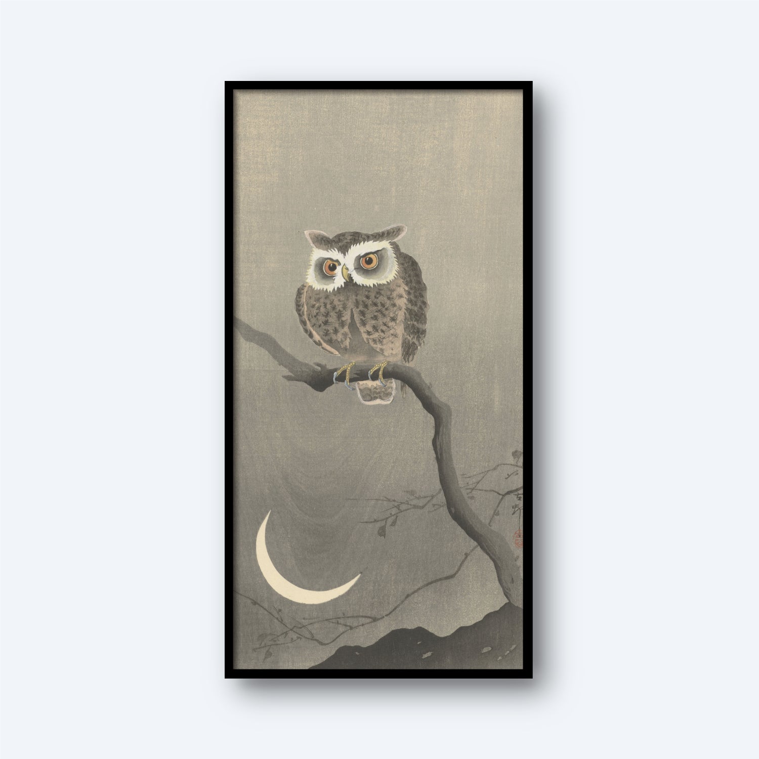 The framed product, titled "Long-eared Owl on Bare Tree Branch by Ohara Koson Vintage Japanese Print," showcases a Long-eared Owl perched on a bare branch against a gray background. Below the owl is a crescent moon, and faint outlines of mountains can be seen at the bottom, evoking the serene nighttime ambiance reminiscent of Ohara Koson's vintage Japanese prints.