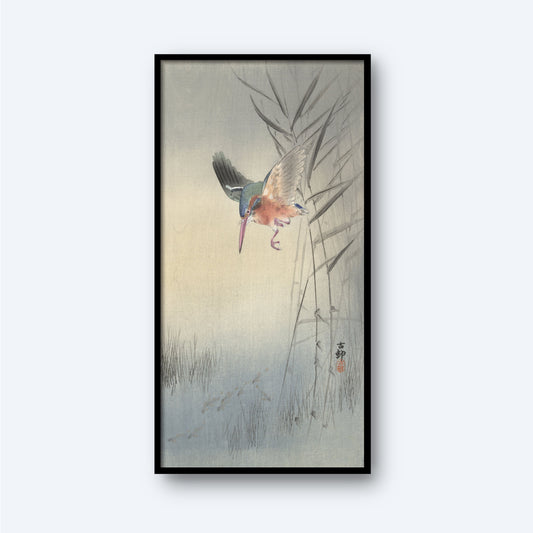 The framed artwork, titled "Kingfisher hunting for fish in the water," showcases a colorful Kingfisher hunting near tall, slender bamboo stalks and grass. The background features a soft gradient of pale colors, creating a serene and natural ambiance. The painting style is traditional and detailed, reminiscent of a vintage Japanese print by Ohara Koson.