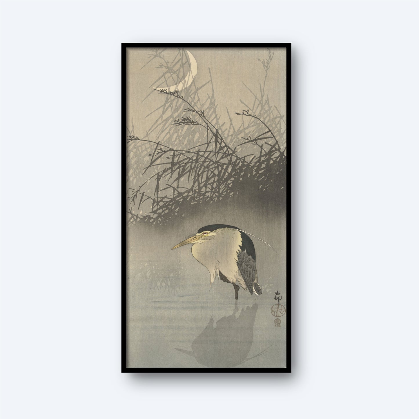 The framed painting titled "Night Heron Under the Crescent Moon" by Ohara Koson beautifully depicts a serene night scene. Featuring a heron standing in shallow water amid tall reeds, the piece is reminiscent of a vintage Japanese print. A crescent moon and some flying insects are visible in the background, adding to the tranquil ambiance with its traditional and minimalist art style.
