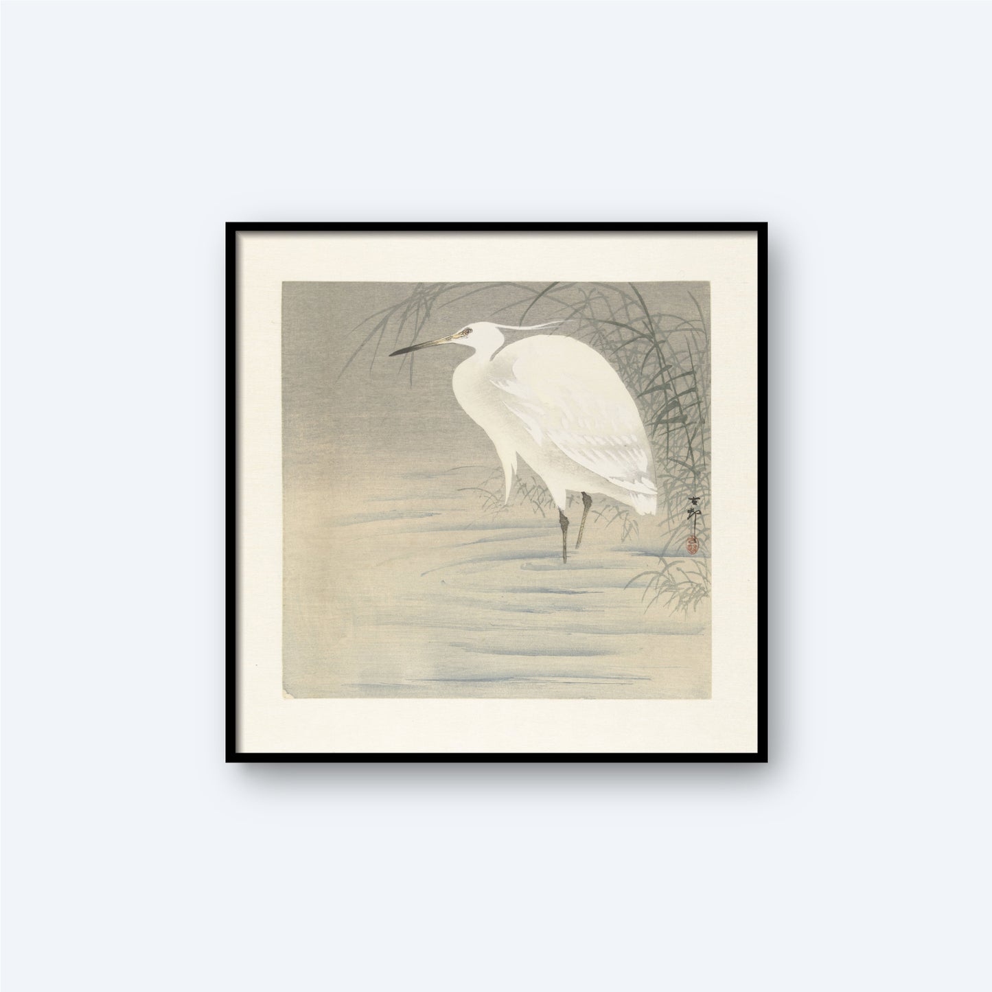 The Little Egret by Ohara Koson, a vintage Japanese print, features a framed artwork of a white egret standing in shallow water with reeds in the background. The scene is reminiscent of Koson's woodblock prints, rendered in a minimalist and monochromatic style with subtle gray and white tones.
